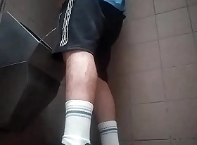 Young guy peeing in a set forth toilet
